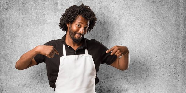 Handsome african american baker proud and confident, pointing fingers, example to follow, concept of satisfaction, arrogance and health - Photo, Image