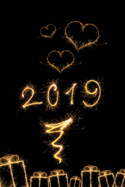 Magical new year. Magical fireworks 2019 with abstract gifts and hearts isolated on black background. Happy new year background. - Fotografie, Obrázek