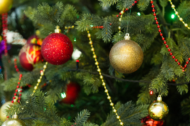 New Year. Celebration. Toys hang on the Christmas tree, background - Фото, изображение