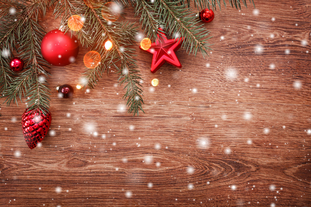 Christmas decorations with fir tree branch on wooden background with snow, blurred, sparking with space for text. Xmas and Happy New Year card - Fotografie, Obrázek