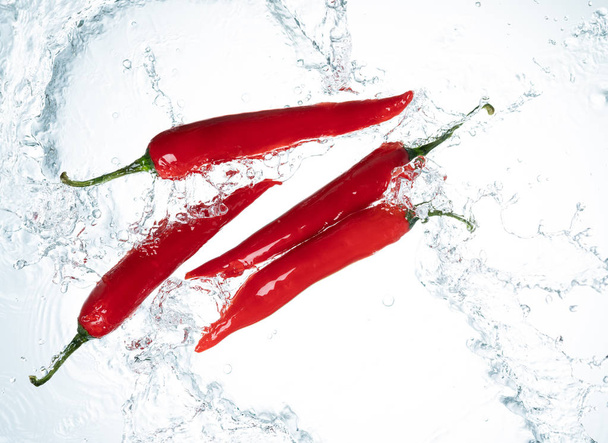 Red Chili Peppers Water Splash on White Background - Фото, зображення