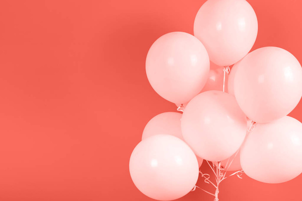Living Coral background with bunch of flying balloons, copy space for text. Color of the year 2019. Christmas, birthday, valentine, wedding, holiday concept - Fotografie, Obrázek