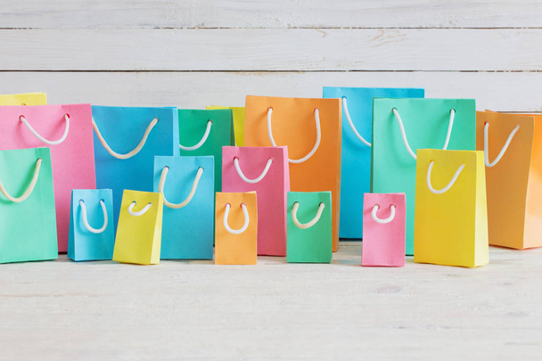 paper bags on white wooden background - Foto, immagini