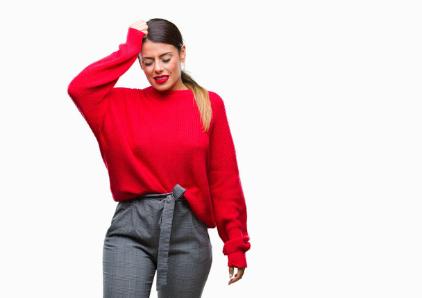 Young beautiful business woman wearing winter sweater over isolated background confuse and wonder about question. Uncertain with doubt, thinking with hand on head. Pensive concept. - Foto, Bild