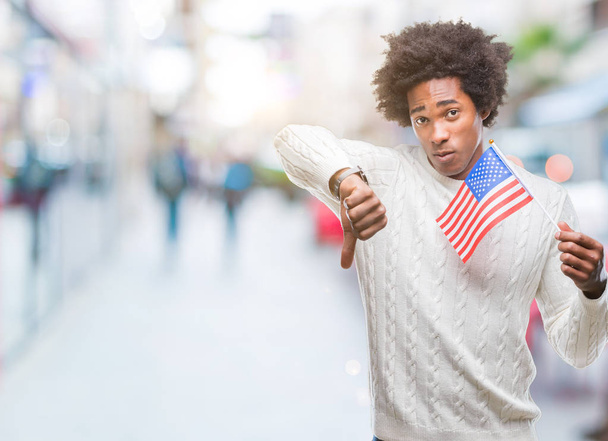 Afro american man flag of United States of America over isolated background with angry face, negative sign showing dislike with thumbs down, rejection concept - Fotografie, Obrázek