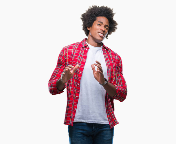 Afro american man over isolated background disgusted expression, displeased and fearful doing disgust face because aversion reaction. With hands raised. Annoying concept. - Foto, imagen