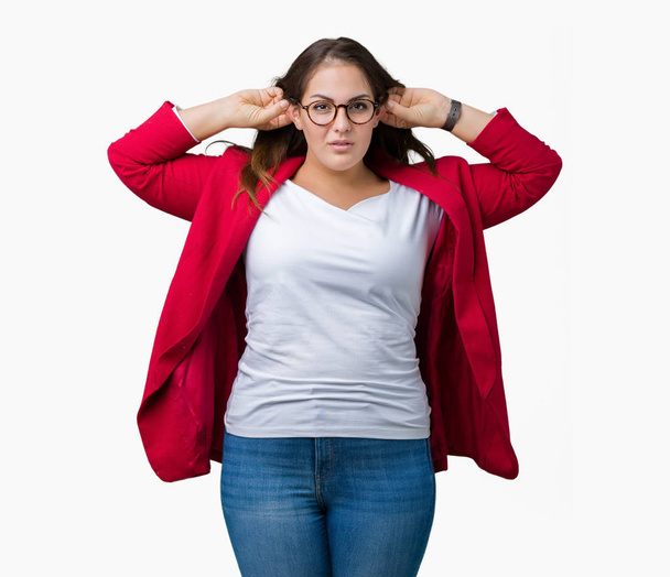 Beautiful plus size young business woman wearing elegant jacket and glasses over isolated background Smiling pulling ears with fingers, funny gesture. Audition problem - Photo, Image