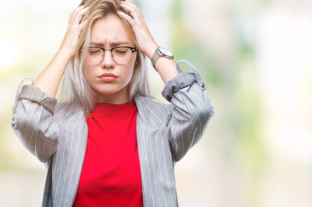 Young blonde business woman wearing fashion jacket over isolated background suffering from headache desperate and stressed because pain and migraine. Hands on head. - Foto, immagini