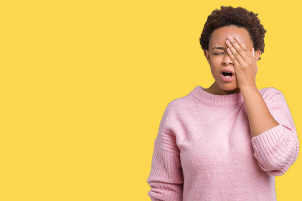 Beautiful young african american woman over isolated background Yawning tired covering half face, eye and mouth with hand. Face hurts in pain. - Photo, Image