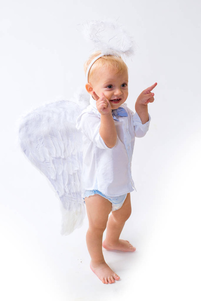 Merry Christmas to you. Christmas angel. Little boy with angel wings and halo. Baby angel. Adorable little angel boy. Cute valentines cupid or cherub baby. Christmas party celebration - Foto, imagen