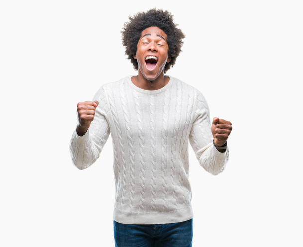 Afro american man over isolated background celebrating mad and crazy for success with arms raised and closed eyes screaming excited. Winner concept - Fotoğraf, Görsel
