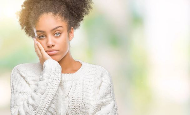 Young afro american woman wearing winter sweater over isolated background thinking looking tired and bored with depression problems with crossed arms. - Photo, Image
