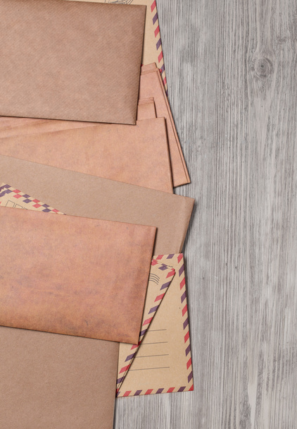 Stack of envelopes on wooden table with copy space - Foto, afbeelding