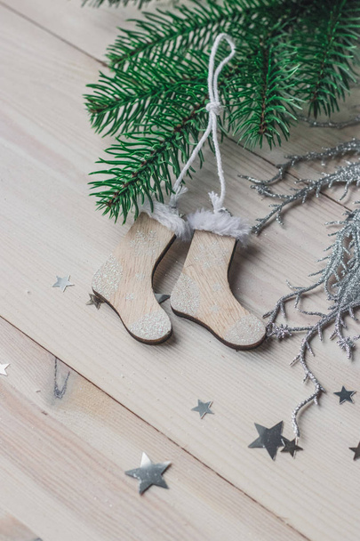 Wooden Christmas decorations - Christmas socks on a white wooden background with a Christmas tree space for text - Photo, Image