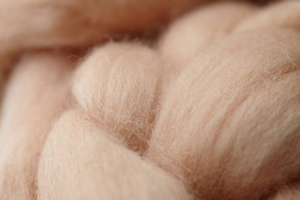 Merino wool handmade knitted large blanket, super chunky yarn, trendy concept. Close-up of knitted blanket, merino wool background. designer blanket made of beige smoky wool - Фото, зображення