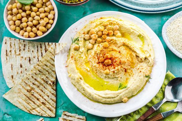 Healthy Homemade Creamy Hummus with Olive Oil and Pita  - Photo, image