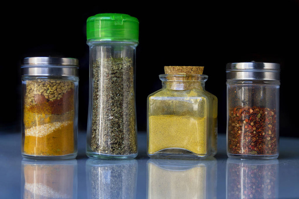 Spice jars over a dark background - 写真・画像