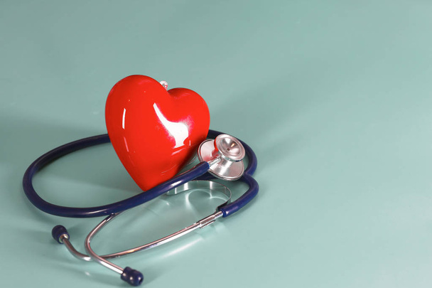 Red heart and a stethoscope on desk - Photo, Image