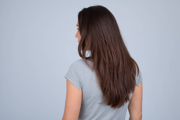 Rear view of young multi-ethnic woman against white background - Fotografie, Obrázek