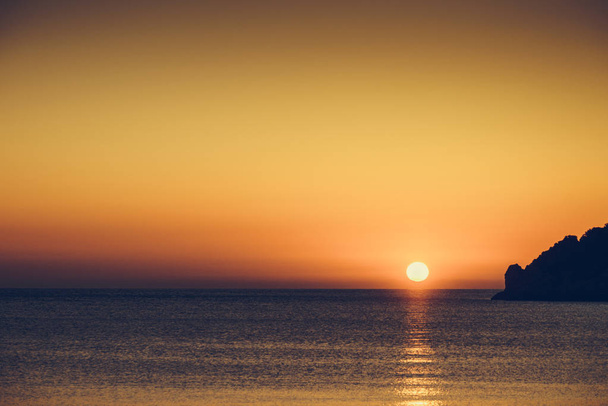 Scenic sunset or sunrise over sea surface. Natural scenery, beautiful landscape - Zdjęcie, obraz