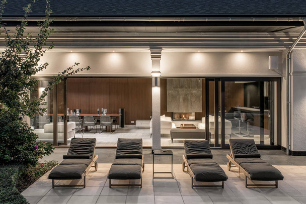 Few deck chairs on tiled terrace of luminous villa - 写真・画像