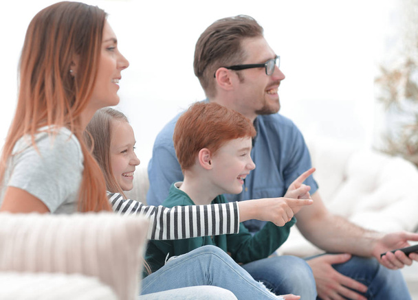 close up. the family watches their favorite show on TV - Φωτογραφία, εικόνα