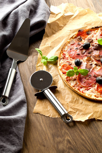 Tasty pizza on wooden table, top view - Valokuva, kuva