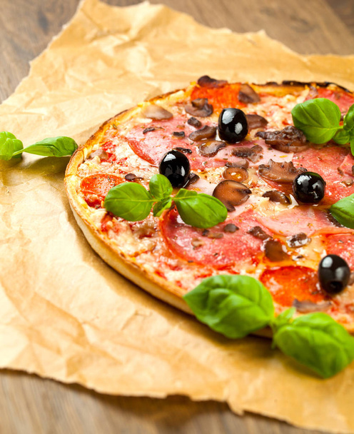 Tasty pizza on wooden table, top view - Valokuva, kuva