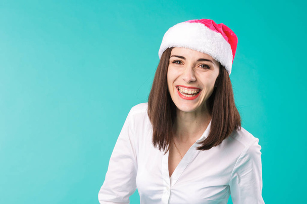 New Year theme Christmas winter holidays office of company employees. portrait young caucasian woman businessman white shirt in funny santa claus hat posing emotion joke, joy happiness laugh grimace. - Photo, image