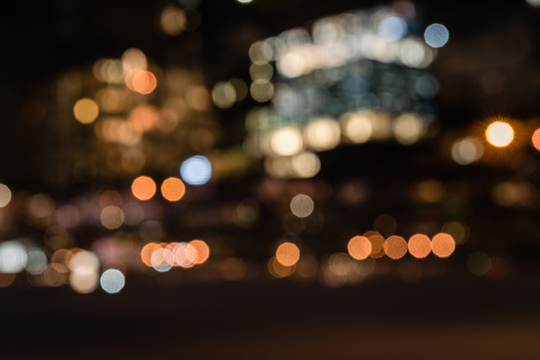 blurred buildings with bokeh lights at night - Photo, Image