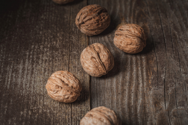 close up view of tasty walnuts on wooden surface - Valokuva, kuva