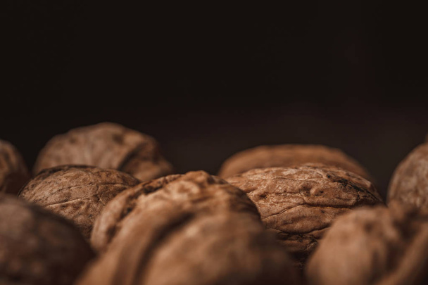 close up view of walnuts on black backdrop - Valokuva, kuva