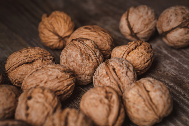 close up view of walnuts on wooden tabletop - Fotoğraf, Görsel