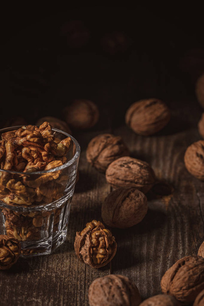 close up view of shelled walnuts in glass on wooden surface - Foto, immagini