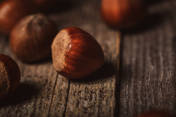 close up view of shelled hazelnuts on wooden tabletop - Zdjęcie, obraz