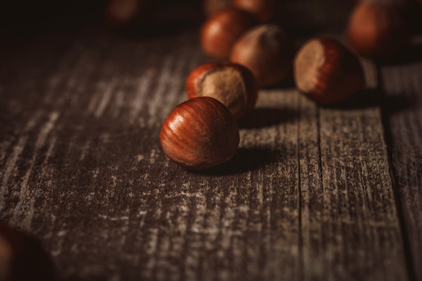close up view of shelled hazelnuts on wooden tabletop - Fotografie, Obrázek