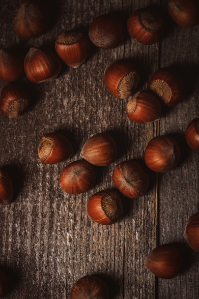 top view of hazelnuts on wooden tabletop - 写真・画像