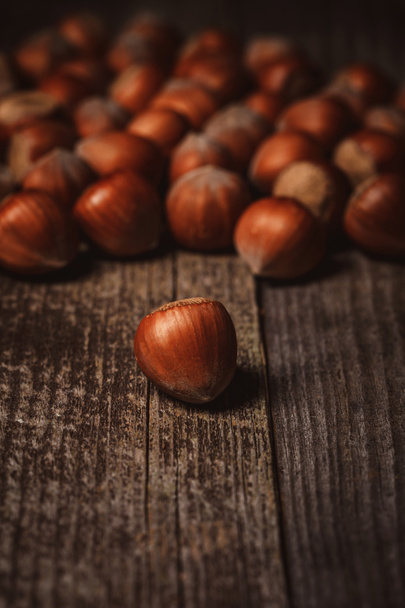 close up view of shelled hazelnuts on wooden backdrop - Zdjęcie, obraz