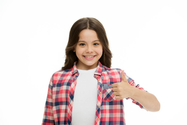 Girl smiling face feels confident. Child confidently showing thumbs up. Upbringing confidence concept. Feel so confident with parental support. I like it. Kid girl long curly hair posing confidently - 写真・画像