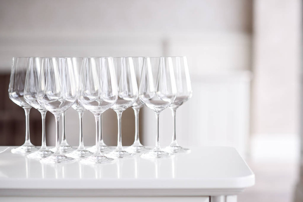 Crystal clear empty wine glasses on the table. Alcohol background. A lot of wine glasses at the bar. - Foto, Imagem