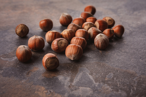 close up view of shelled hazelnuts on grey tabletop - Photo, Image