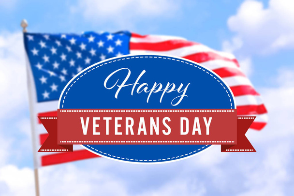 Text HAPPY VETERANS DAY with USA flag against blue sky - Фото, изображение
