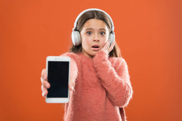 Outdated application version. Best free music apps. Listen for free. Get music account subscription. Enjoy music concept. Enjoy perfect sound. Girl child listen music modern headphones and smartphone - 写真・画像