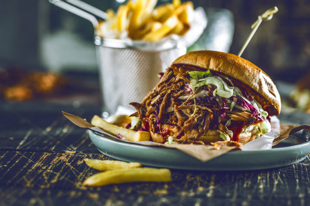 homemade pulled pork burger with bbq sauce close up - Фото, изображение