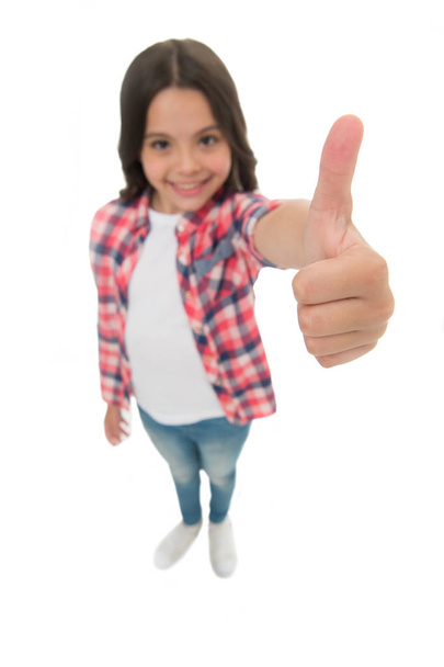 Kid girl long curly hair posing confidently. Girl smiling face feels confident. Child confidently showing thumbs up. Upbringing confidence concept. Feel so confident with parental support. I like it - Foto, imagen