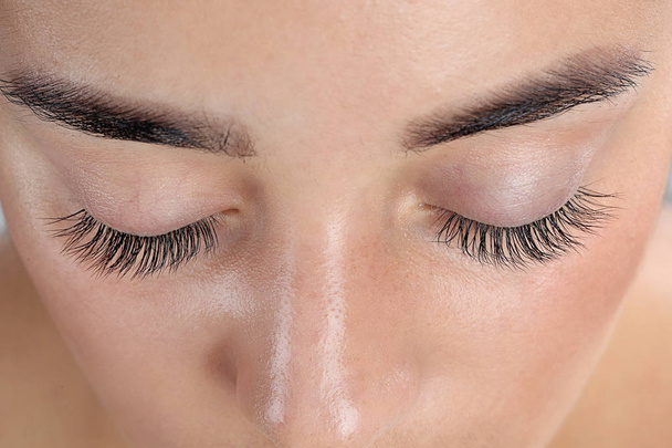 Young woman with beautiful eyelashes, closeup view - 写真・画像