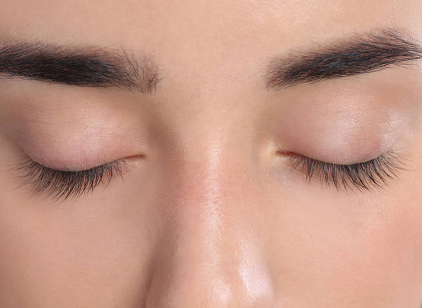 Young woman with beautiful natural eyelashes, closeup view - Фото, зображення
