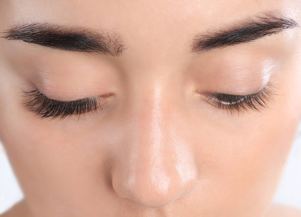 Young woman with beautiful eyelashes, closeup view - 写真・画像