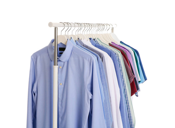Men clothes hanging on wardrobe rack against white background - Foto, afbeelding