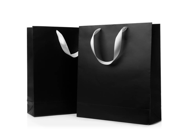 Paper shopping bags with ribbon handles on white background. Mockup for design - Foto, immagini